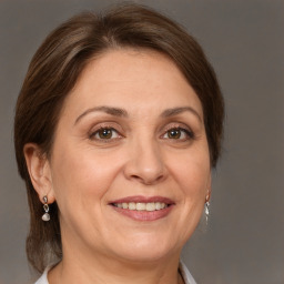 Joyful white adult female with medium  brown hair and grey eyes