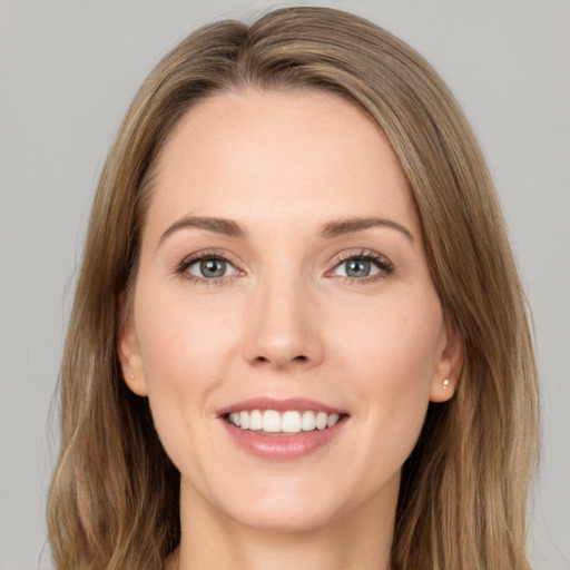 Joyful white young-adult female with long  brown hair and green eyes