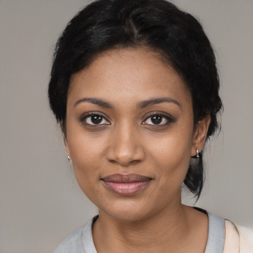 Joyful black young-adult female with medium  black hair and brown eyes