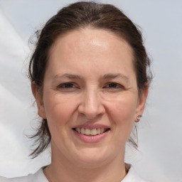 Joyful white adult female with medium  brown hair and brown eyes