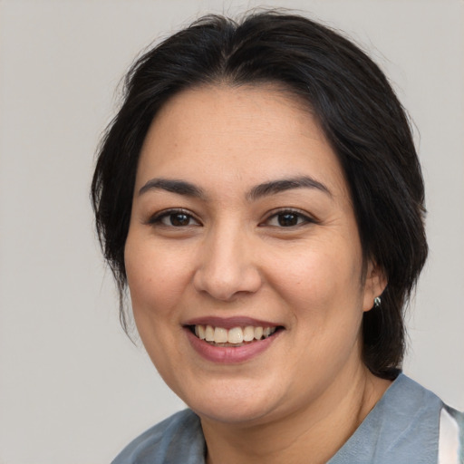 Joyful asian young-adult female with medium  brown hair and brown eyes