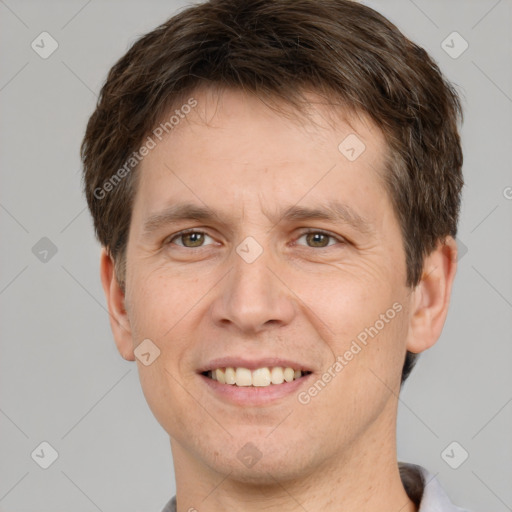 Joyful white adult male with short  brown hair and brown eyes