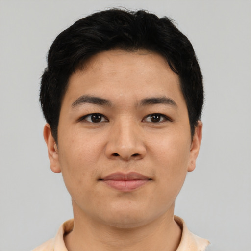 Joyful asian young-adult male with short  black hair and brown eyes