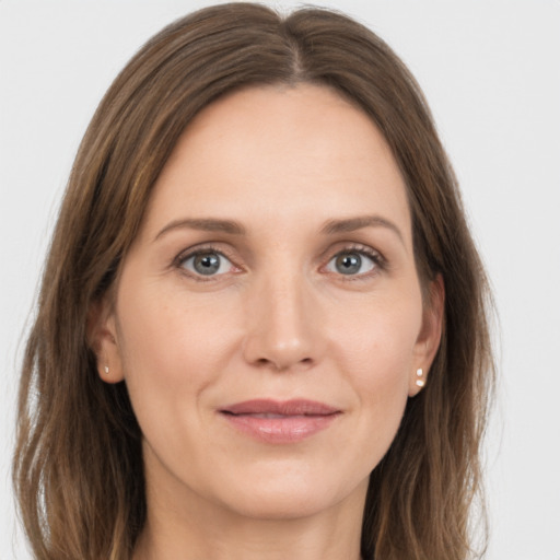 Joyful white young-adult female with long  brown hair and grey eyes