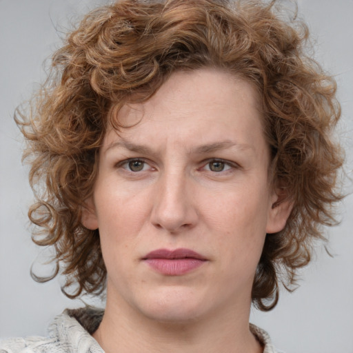 Joyful white adult female with medium  brown hair and blue eyes