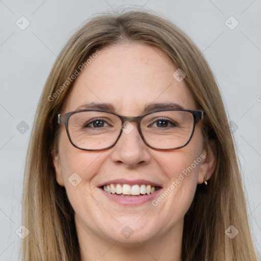 Joyful white adult female with long  brown hair and grey eyes