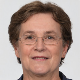 Joyful white middle-aged female with medium  brown hair and brown eyes