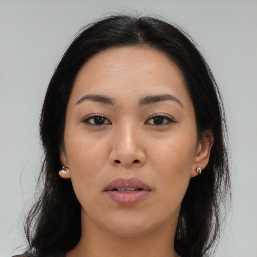 Joyful asian young-adult female with long  brown hair and brown eyes