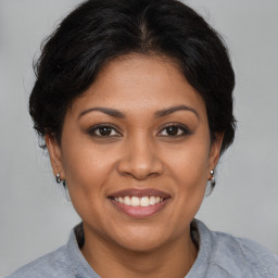 Joyful latino young-adult female with medium  brown hair and brown eyes