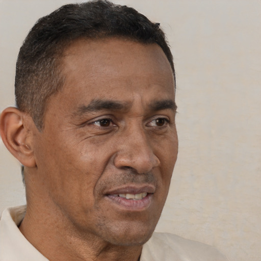 Joyful black adult male with short  brown hair and brown eyes