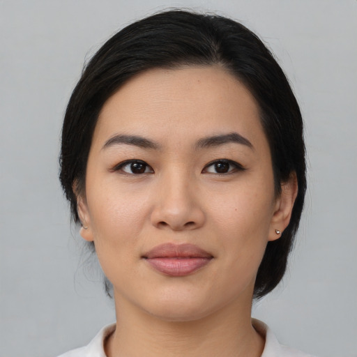 Joyful asian young-adult female with medium  black hair and brown eyes