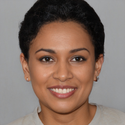 Joyful latino young-adult female with short  brown hair and brown eyes