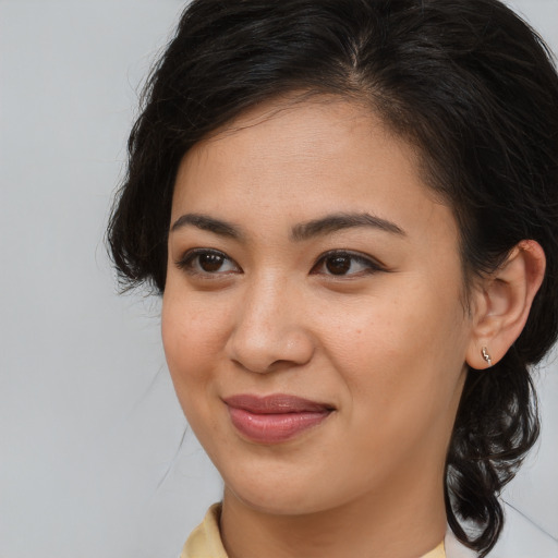 Joyful latino young-adult female with medium  brown hair and brown eyes