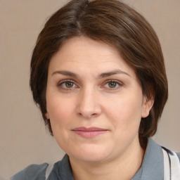 Joyful white adult female with medium  brown hair and brown eyes