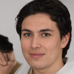 Joyful white young-adult male with medium  brown hair and brown eyes