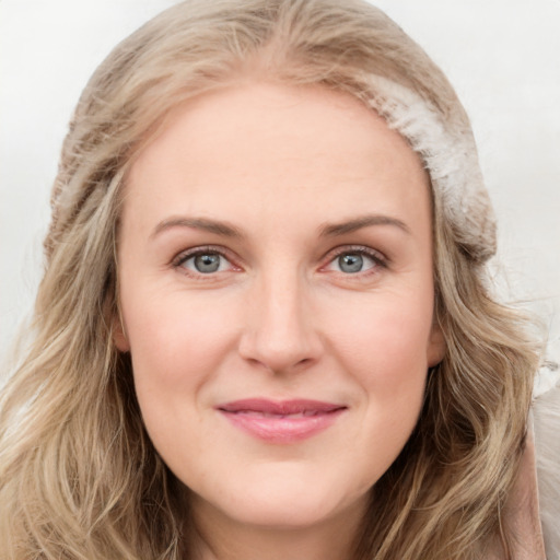 Joyful white young-adult female with long  brown hair and blue eyes