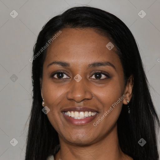 Joyful black young-adult female with long  black hair and brown eyes