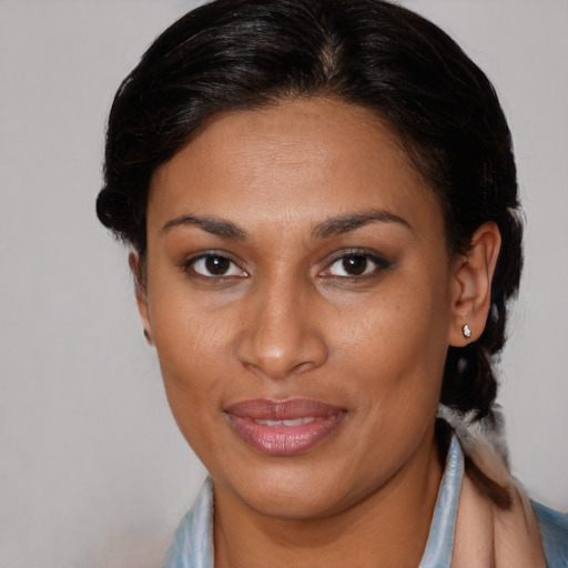Joyful latino adult female with short  brown hair and brown eyes