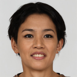 Joyful asian young-adult female with short  brown hair and brown eyes