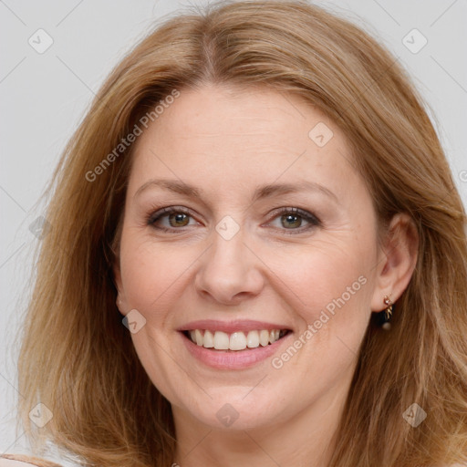 Joyful white adult female with long  brown hair and brown eyes