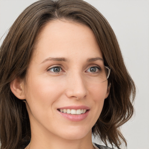 Joyful white young-adult female with medium  brown hair and blue eyes