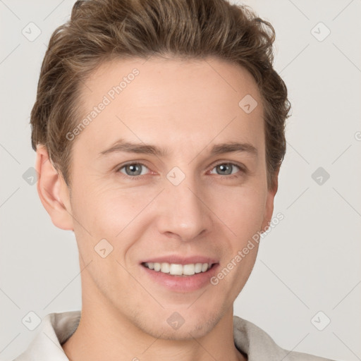 Joyful white young-adult male with short  brown hair and grey eyes