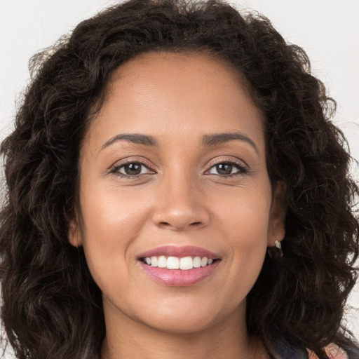 Joyful white young-adult female with long  brown hair and brown eyes