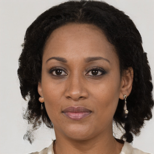 Joyful black adult female with medium  black hair and brown eyes