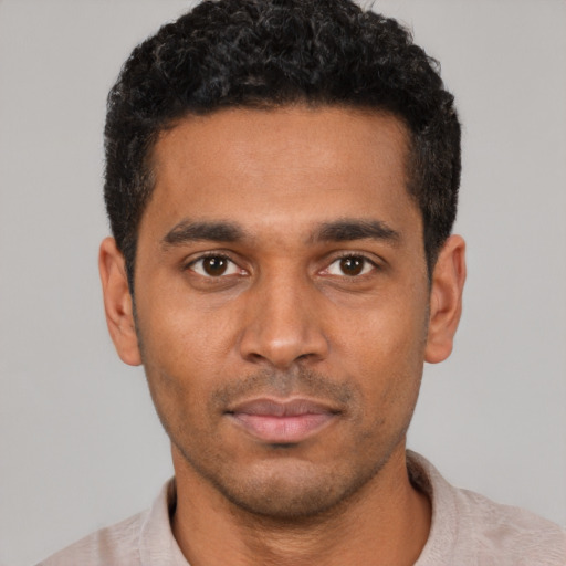Neutral black young-adult male with short  black hair and brown eyes