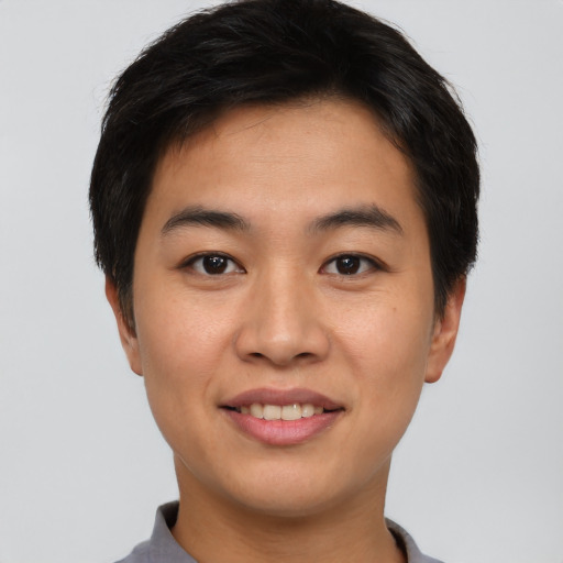 Joyful asian young-adult male with short  brown hair and brown eyes
