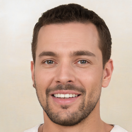 Joyful white young-adult male with short  brown hair and brown eyes