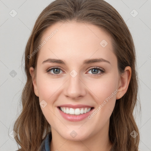 Joyful white young-adult female with long  brown hair and blue eyes