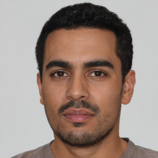 Neutral latino young-adult male with short  black hair and brown eyes