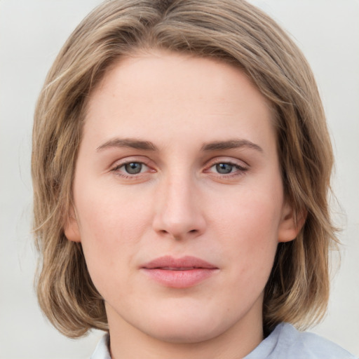 Joyful white young-adult female with medium  brown hair and green eyes