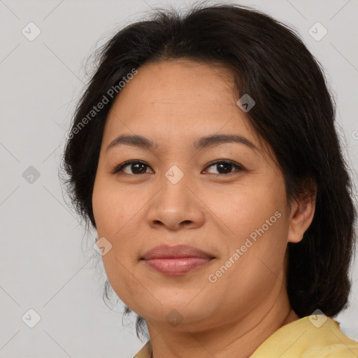 Joyful asian adult female with medium  brown hair and brown eyes