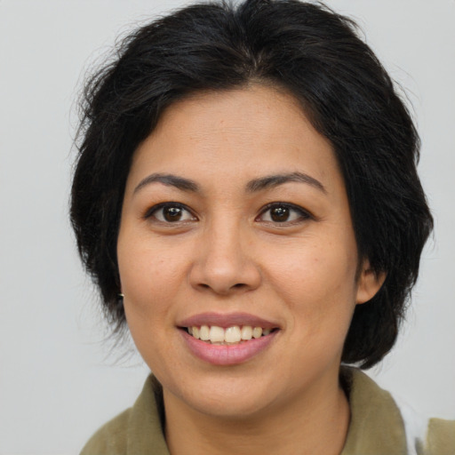 Joyful asian young-adult female with long  brown hair and brown eyes