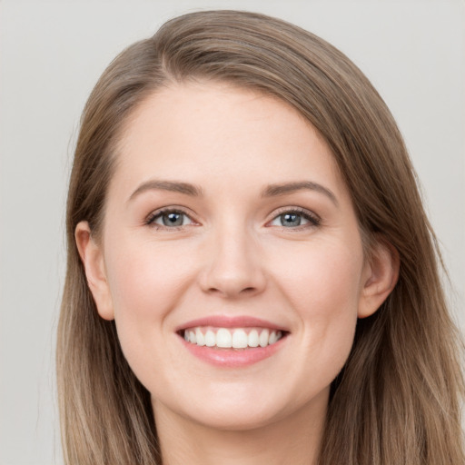 Joyful white young-adult female with long  brown hair and grey eyes