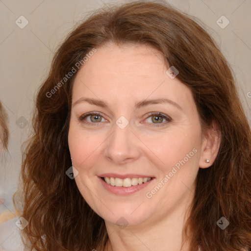 Joyful white adult female with long  brown hair and brown eyes