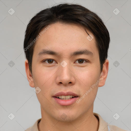 Joyful asian young-adult male with short  brown hair and brown eyes