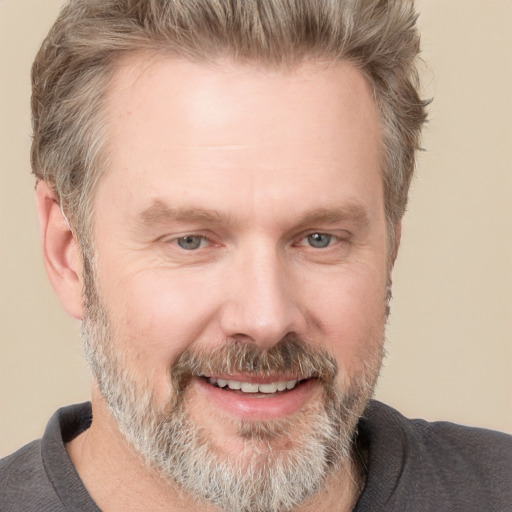 Joyful white adult male with short  brown hair and grey eyes