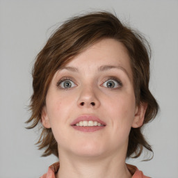 Joyful white young-adult female with medium  brown hair and blue eyes