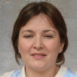 Joyful white adult female with medium  brown hair and brown eyes