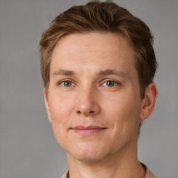 Joyful white adult male with short  brown hair and grey eyes