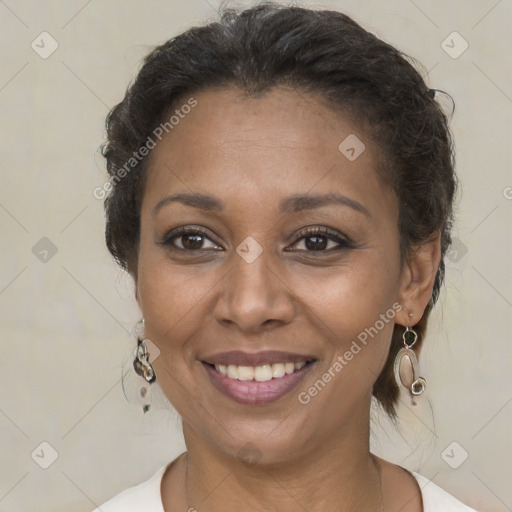 Joyful black adult female with medium  brown hair and brown eyes