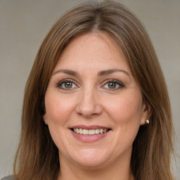 Joyful white adult female with long  brown hair and brown eyes