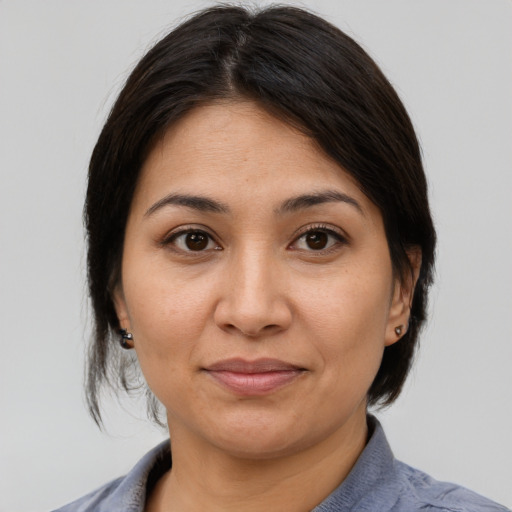 Joyful asian young-adult female with medium  brown hair and brown eyes