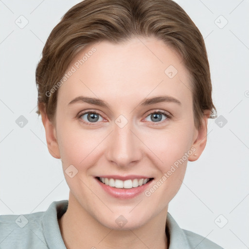 Joyful white young-adult female with short  brown hair and grey eyes