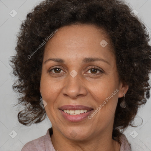 Joyful black adult female with medium  brown hair and brown eyes