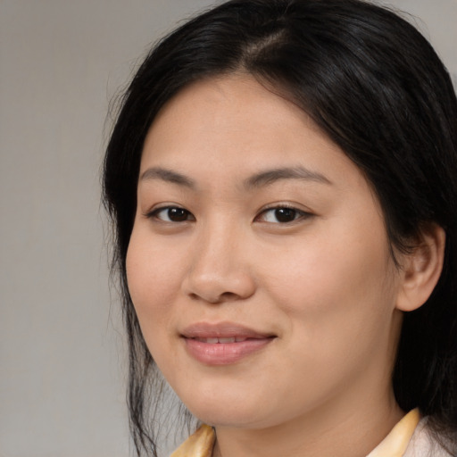 Joyful asian young-adult female with medium  brown hair and brown eyes