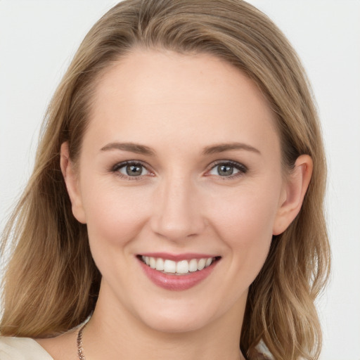 Joyful white young-adult female with long  brown hair and blue eyes